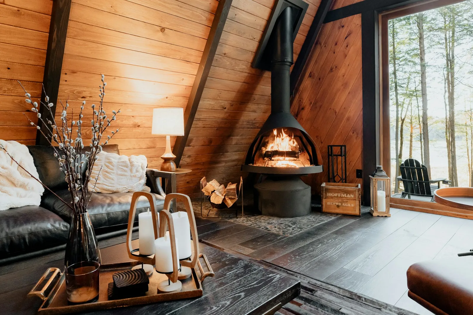 A warm living room with a wood stove and big windows